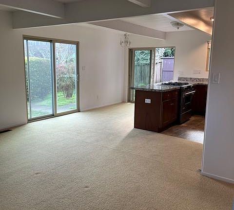 View from front door to living & dining rooms. Two sliders provide access to rear and side yards.