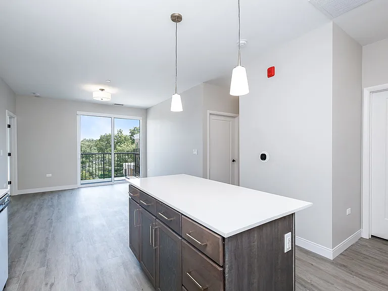 Kitchen with stainless steel whirlpool appliances, quartz countertops, floating shelves and two tone cabinets