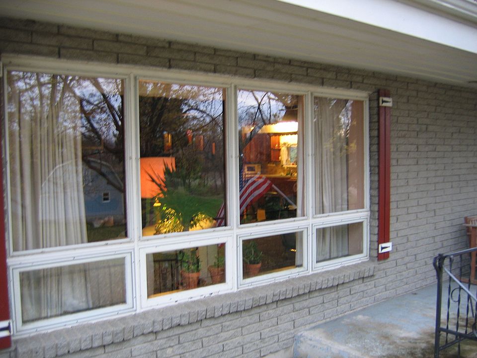 Side Porch Living Room Window Reflecting the Barn