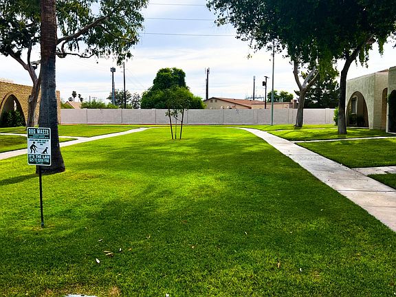 Walkway in front of home . Expansive front yard- natural grass maintained by HOA.