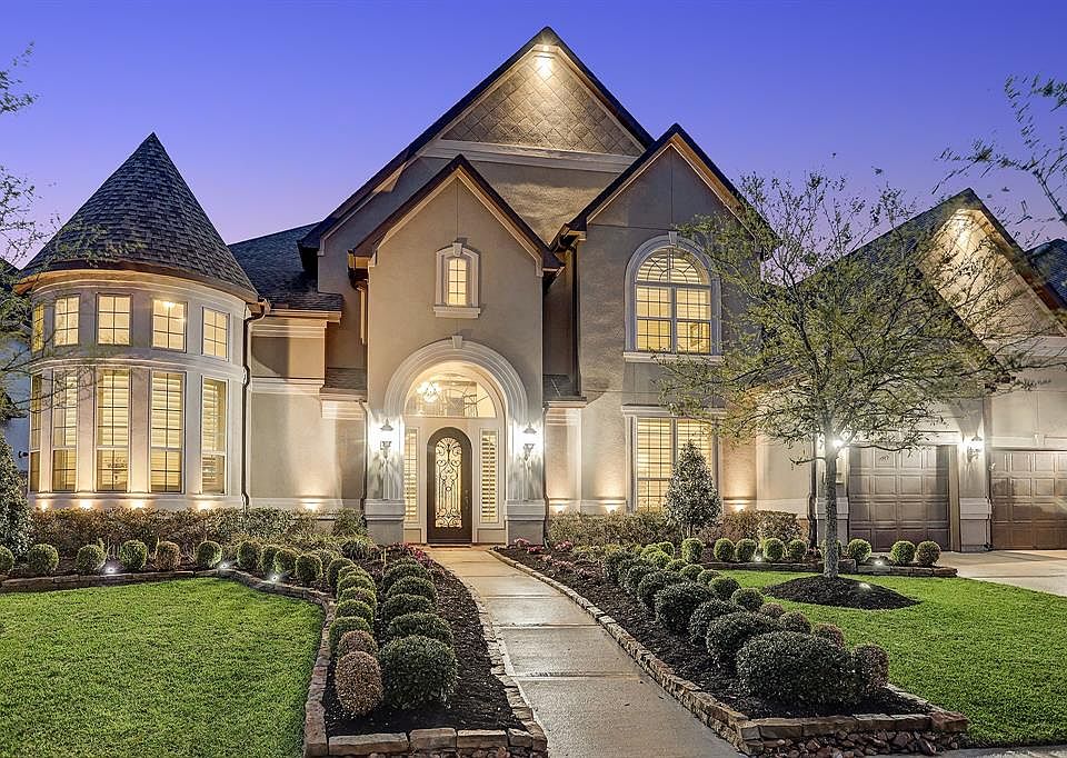 This is THE ONE! Elegant finishes and architectural details are found throughout: hardwood floors on the first floor, soft neutral paint, art niches, plantation shutters, upgraded lighting, twin sweeping staircases, a soaring coffered ceiling and flo