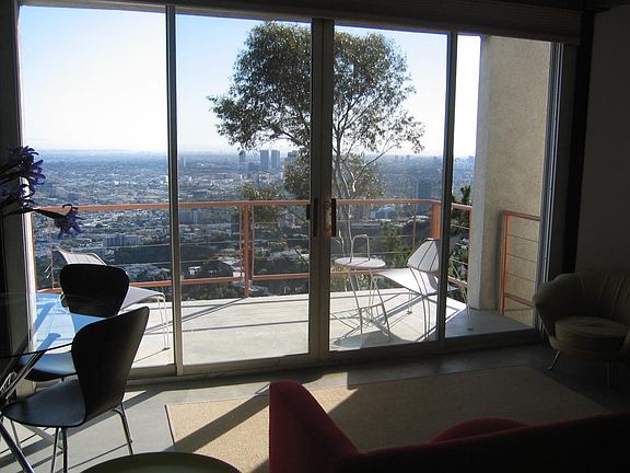 top living area and balcony overlooking the city