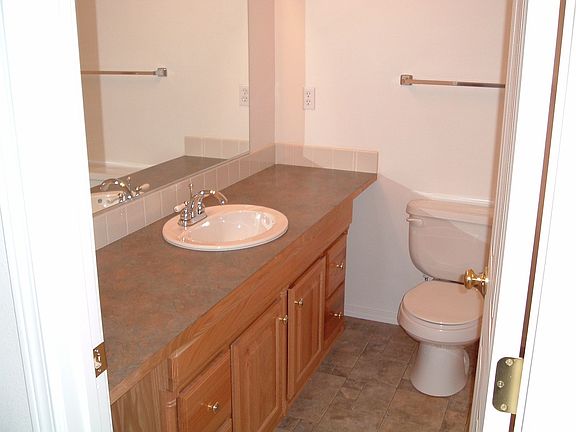 secound bath shower and tub are to the right of the toliet