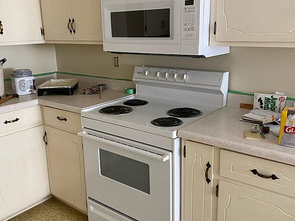 Kitchen with electric stove/oven, Microwave/range hood, and Dishwasher.