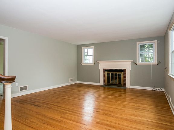 Wood burning fireplace flanked by windows