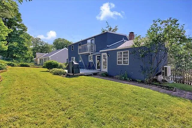 fully fenced in back yard with deck and grill area