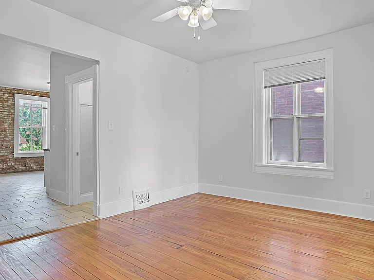 Living room, high ceilings, looking into the kitchen on the left just past the bathroom on the right