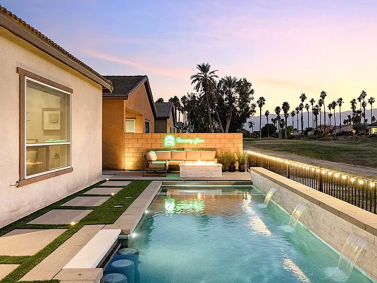 The home is beautifully illuminated in the evening.