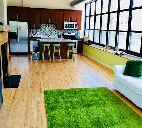 High ceiling sunny living room that separate two bedrooms