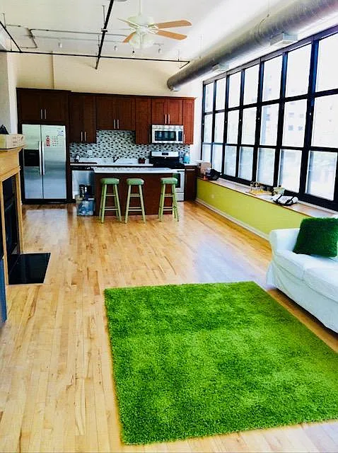 High ceiling sunny living room that separate two bedrooms