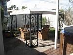 Back yard has a lovely garden a patio and a deck