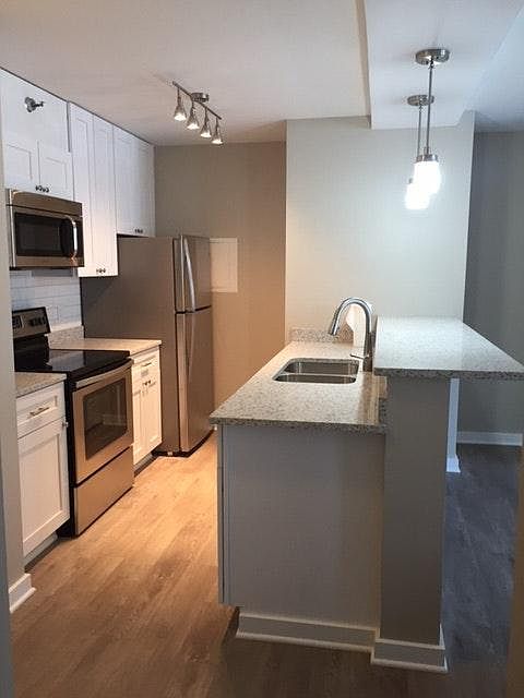 Open kitchen with breakfast bar, quartz counters, new cabine
