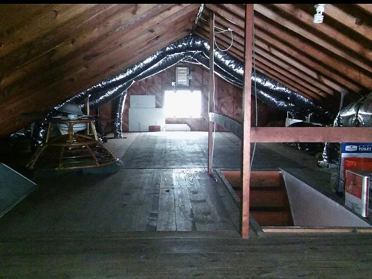 Walk in attic with thermostat vent fan that sweeps hot air out.