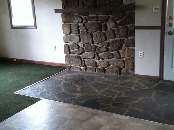 Stone wall, flagstone floor between kitchen/living room