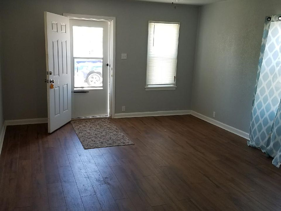 Large open living room that opens up into kitchen