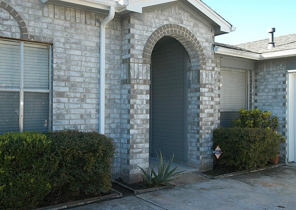 ARCHED COVERED ENTRY OFFERS SHELTER.