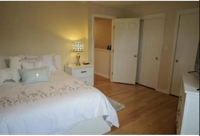 large, light, 3rd floor bedroom with ceiling fan and double closet (photo taken from opposite side)