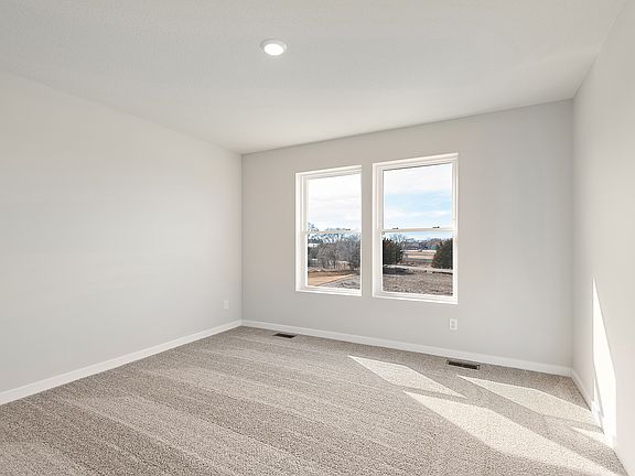 The master bedroom is spacious with a large window.