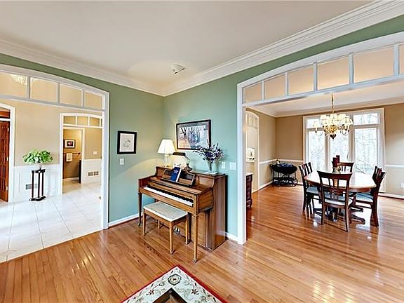 Open living and dining rooms with hardwood flooring.