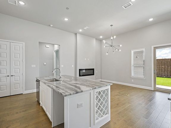 Open living space in in the Renoir home plan by Trophy Signature Homes - REPRESENTATIVE PHOTO