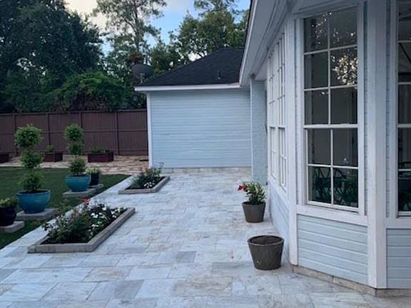 Extended patio with this wonderful tile. Added many flower beds!