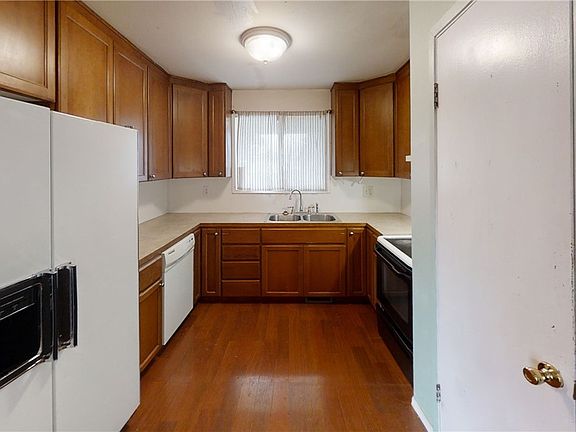 Kitchen has plenty of cupboard space and counter space with pantry for extra storage.
