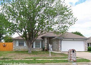 Fully bricked home with beautiful tree in the front yard