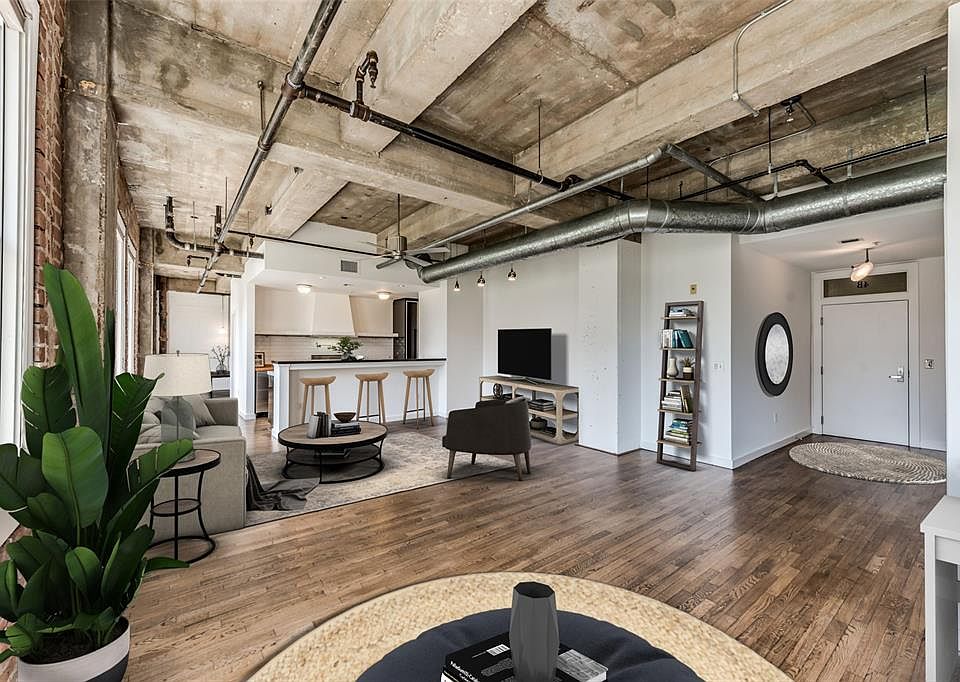 The epitome of urban Downtown loft living. This unit at historic Hermann Lofts features a "lofty" floorplan with wide open spaces and spectacular architectural elements! Ready for move-in or offers an opportunity to update Kitchen & Baths. Oak hardwo