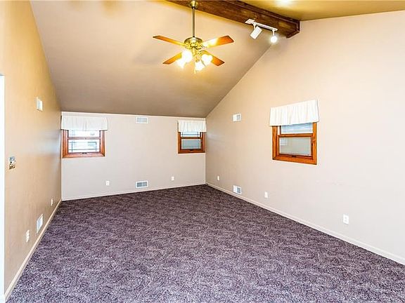 Large main level family room with newer carpet and vaulted ceiling is a nice place to congregate for family movie nights or ente