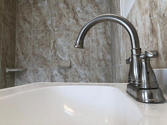 New fixtures in bathroom, and tile shower.