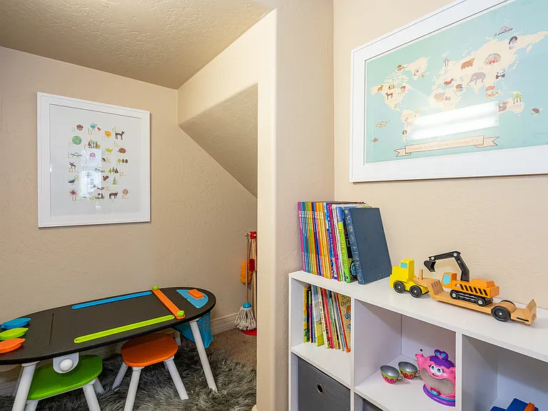 Kid nook located downstairs in bedroom closet under stairs