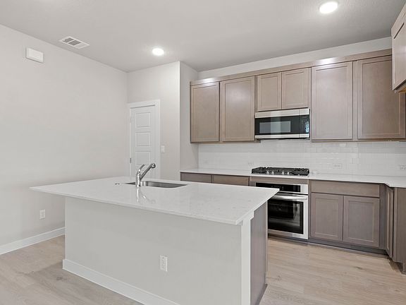 Kitchen in the Willow home plan by Trophy Signature Homes - REPRESENTATIVE PHOTO