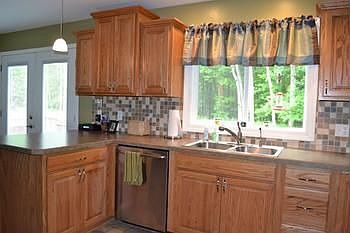Another view of the very beautifully decorated kitchen.  You will notice the islandbar at the end of the kitchen that could be a great place for an easy breakfast nook.  The french door to the left of the kitchen leads out to the large deck, which is great for relaxing in the summer months.  