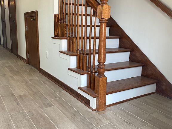 Living Room Staircase
New ceramic tile floors and New wood staircase. New energy efficient Central A/C and Heater Unit.