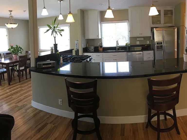 Open concept kitchen and dining areas, with bunch of natural light pouring in the house.