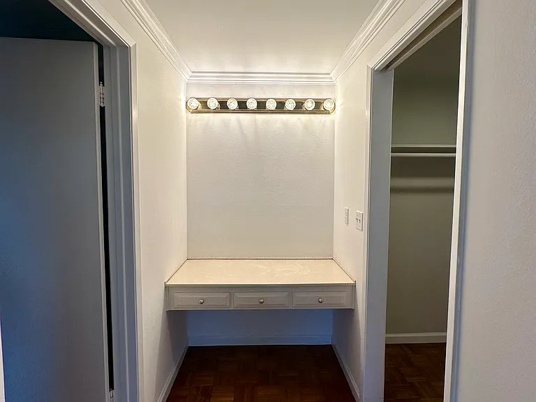View of dressing area, walk-in closet and bathroom
