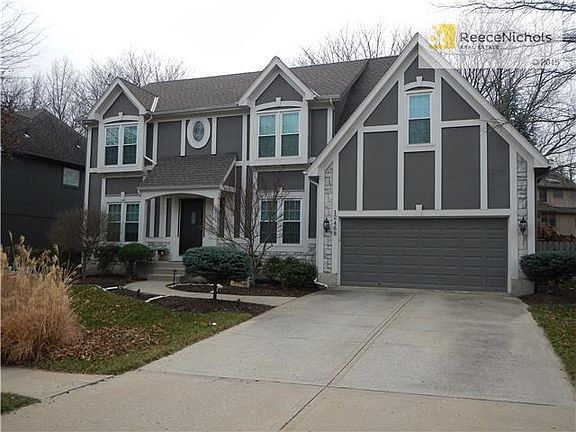 Nicely landscaped home with treed, fenced yard with sprinkler system