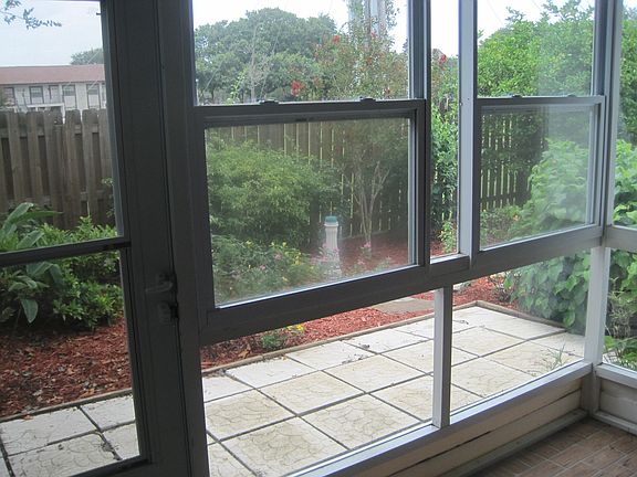 Sunroom leads to fenced-in backyard