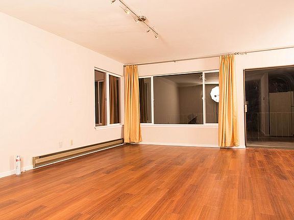 open floor plan living room facing back yard deck