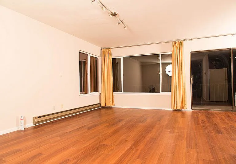 open floor plan living room facing back yard deck