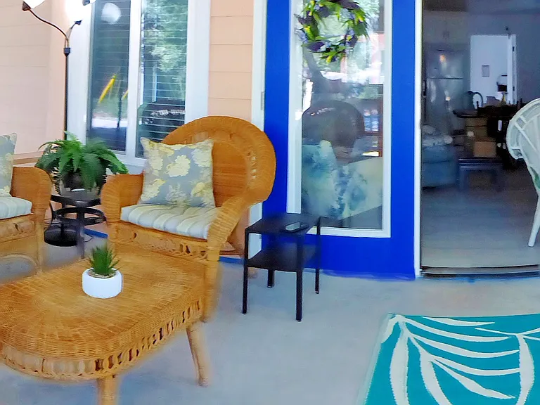 The front screened porch has ample seating for everyone to enjoy the outdoors and view without getting eaten by any bugs.