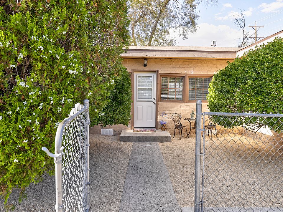 Side entrance offers direct access to the spacious family room. The side yard features a decomposed granite surface and is fully enclosed by a metal fence-private, practical and full of potential.