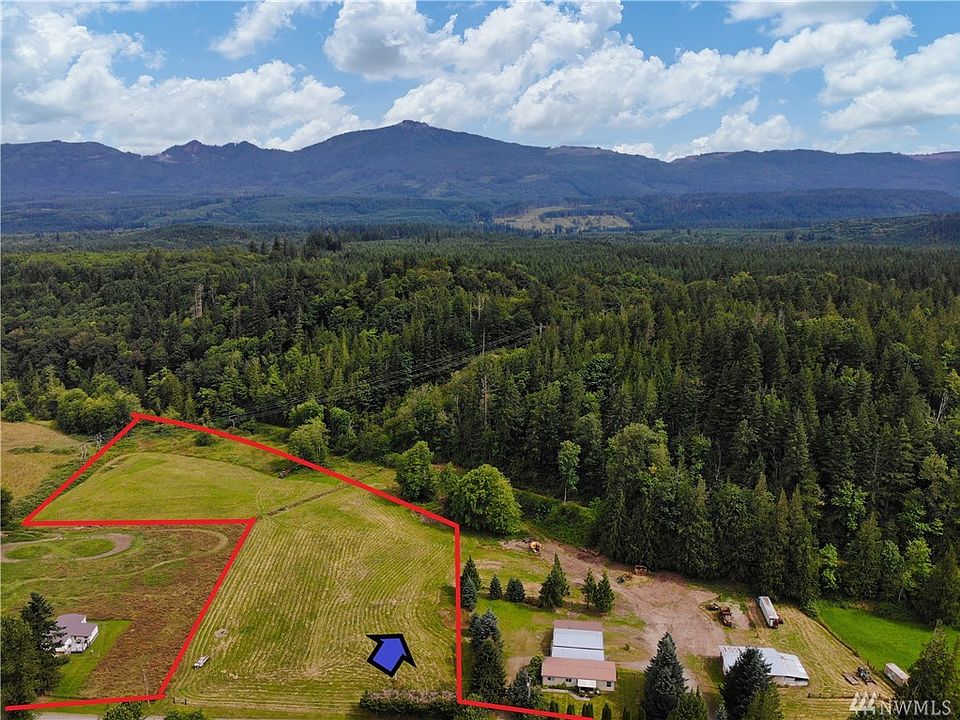 Approximate outline of property. The blue arrow points to the approximate location of the well. The neighboring mobile, shops and 2+ acres to the East is also for sale. See listing 1623713