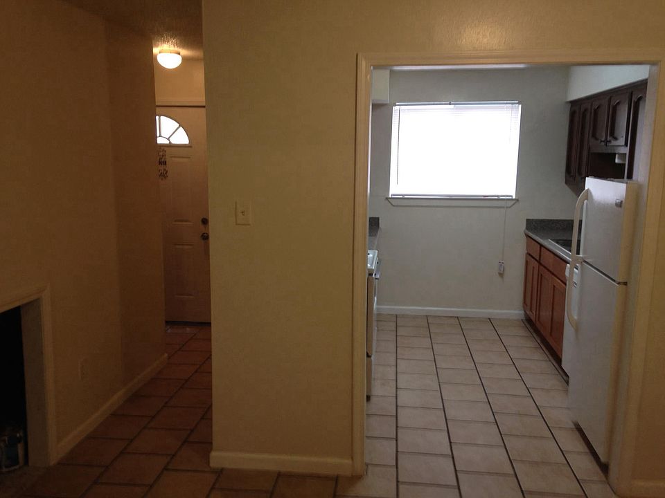 View into kitchen from den, front door to left
