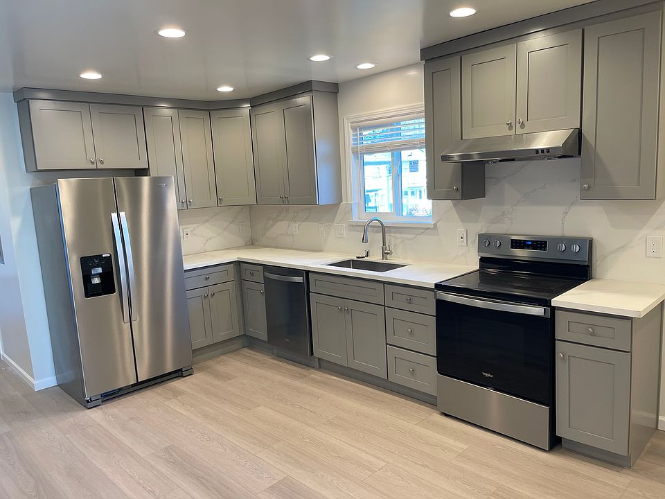 newly remodeled kitchen with new countertops, cabinets, refrigerator, dishwasher, oven and stove