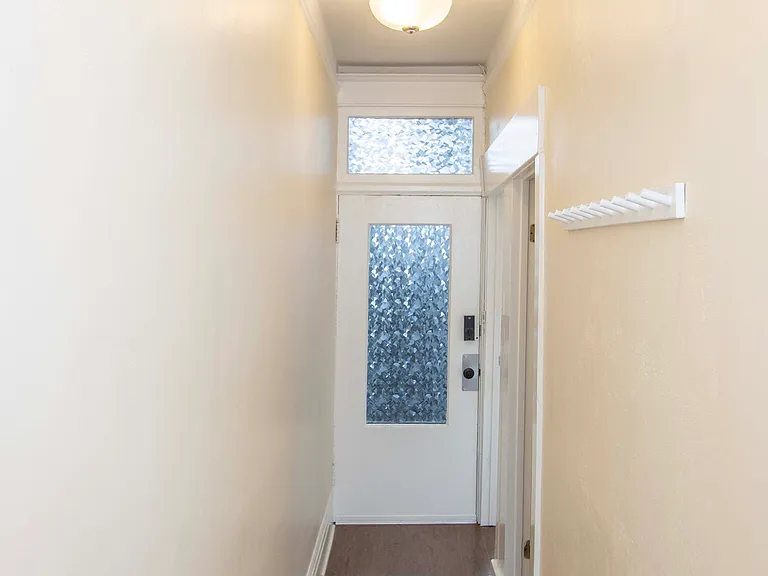 Front door as viewed from the end of the hall (near the entrance to the Living Room)