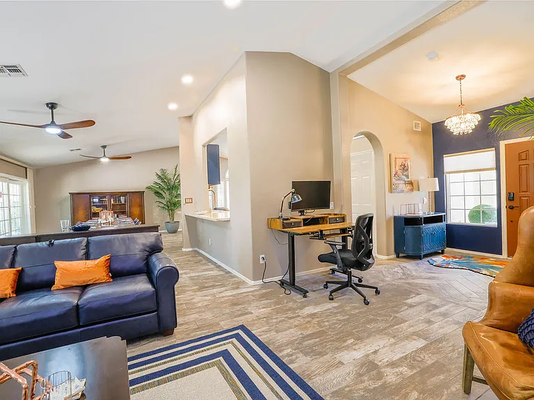 Open plan living room, dining room, kitchen, entry way.
Living room has 2 leather couches with queen size hide away bed, dining table seats 10, sliding door to patio seating