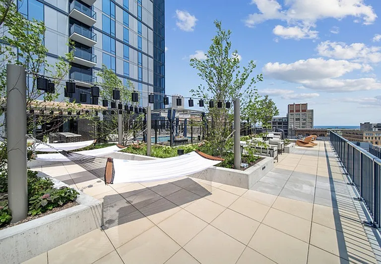 Hangout in the heights _ a rooftop escape where hammocks, greenery, and skyline views invite total relaxation.