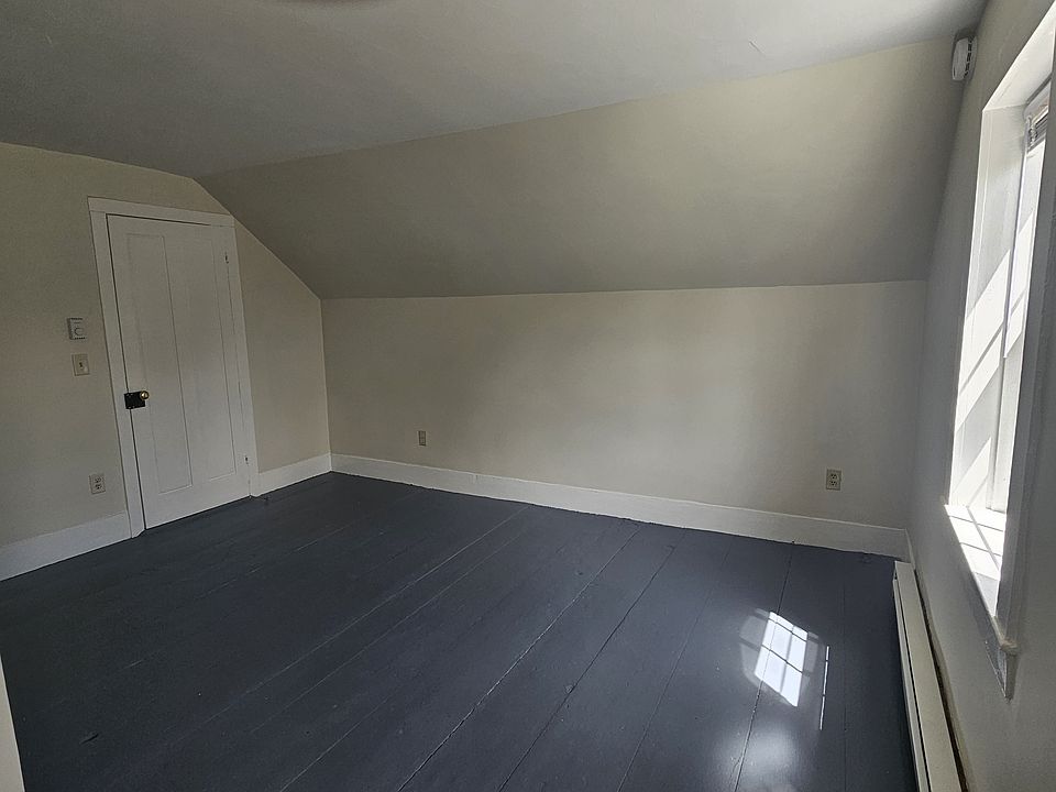Partial view of the spacious bedroom with wood floor