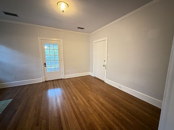 This is your first peek inside the space. The solid door opens to the interior public hallway. The glass door opens to the balcony.